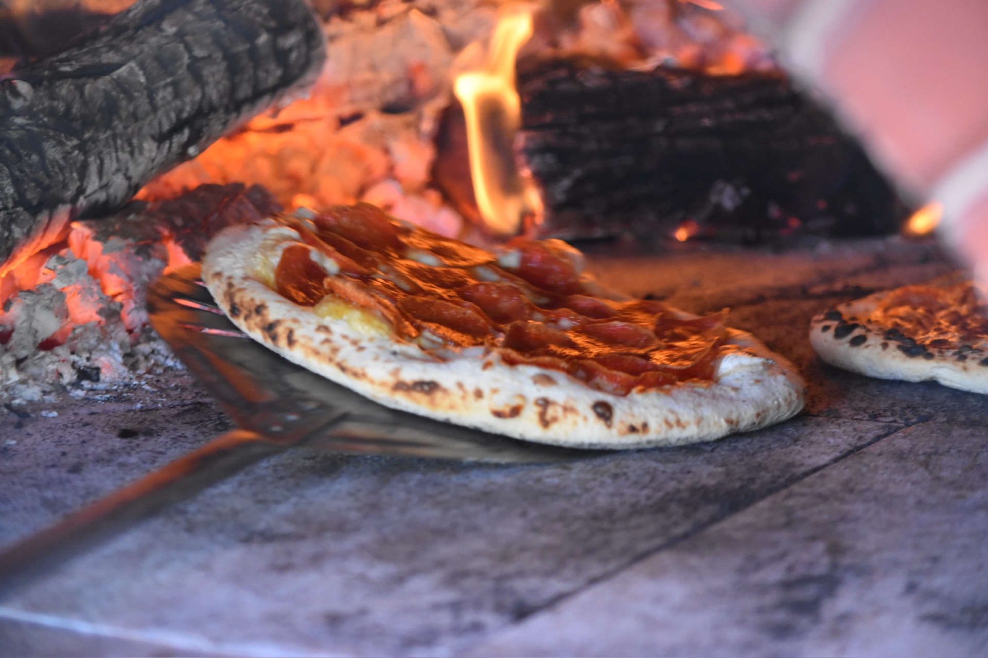 Wood-fired pizza being made