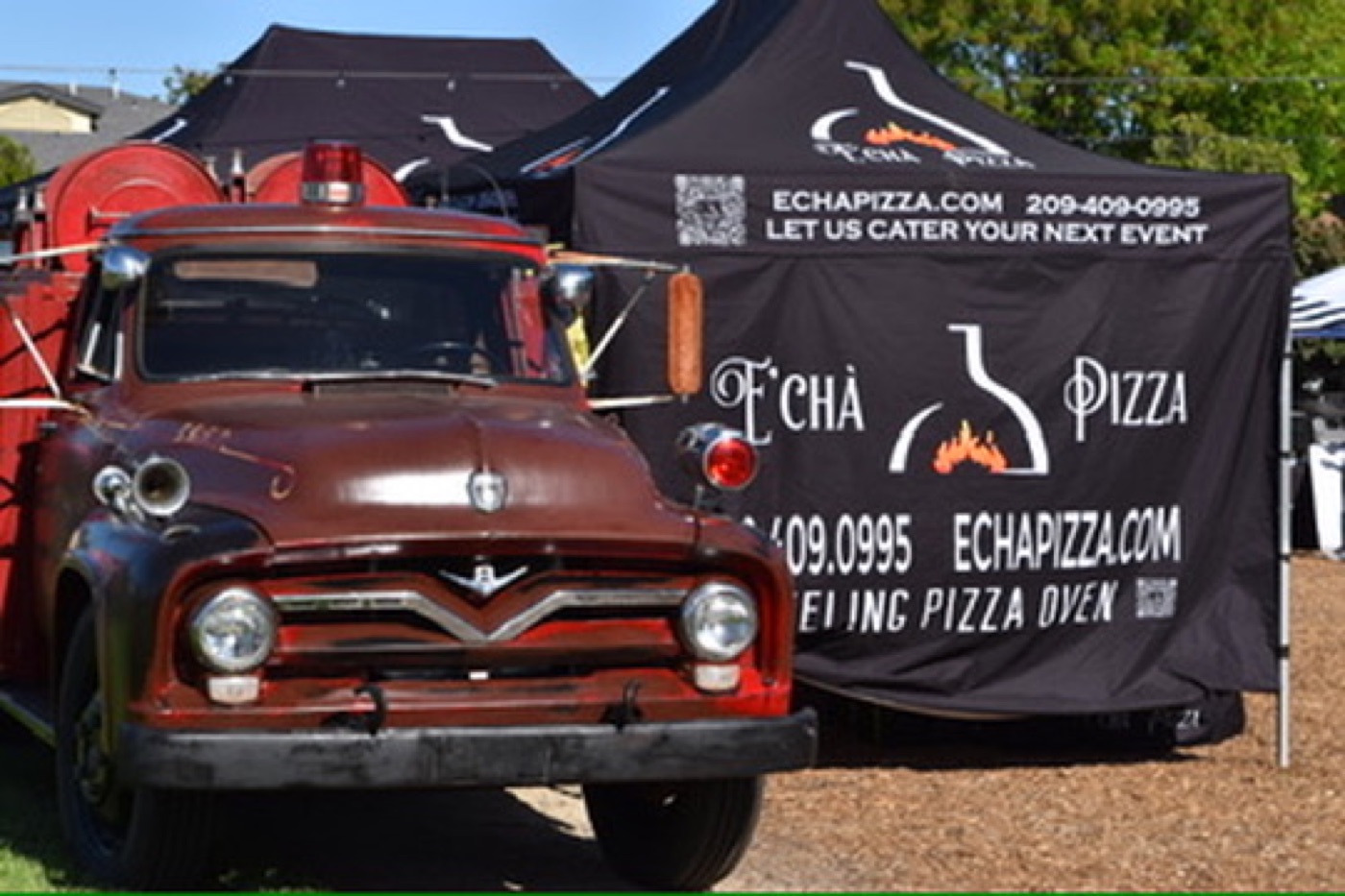 Echa Pizza fire truck and branded tent at an event